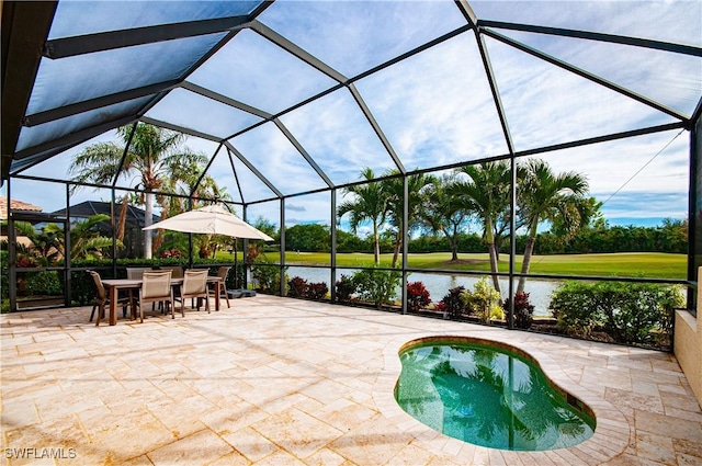 view of patio / terrace with glass enclosure and a water view