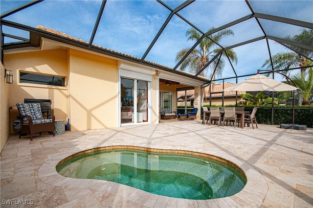 view of pool featuring a lanai, ceiling fan, and a patio