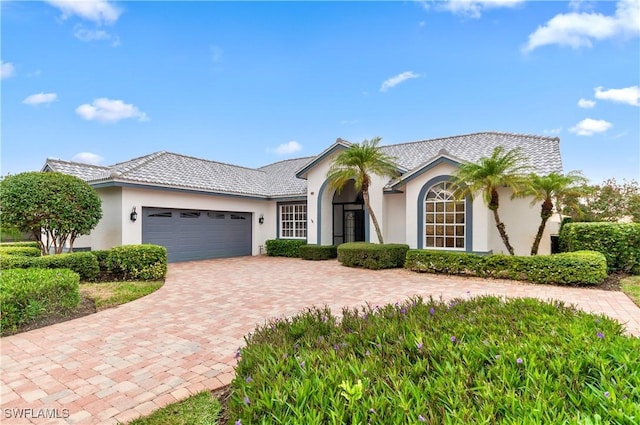 28480 Rochester Ct, Bonita Springs, FL 34135 - view of front facade with a garage