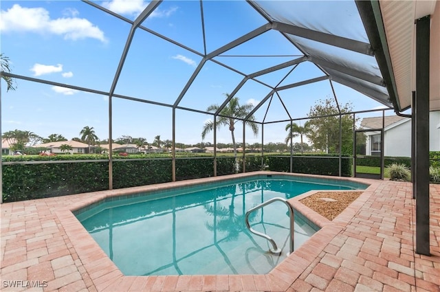 view of swimming pool featuring a lanai and a patio area