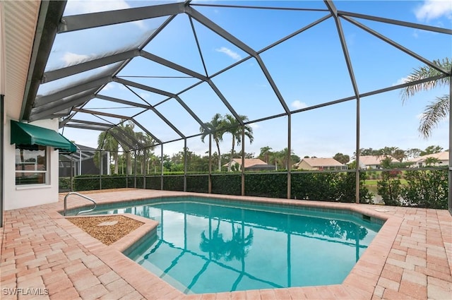 view of swimming pool featuring a patio and glass enclosure