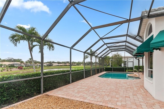 view of pool with a patio and glass enclosure