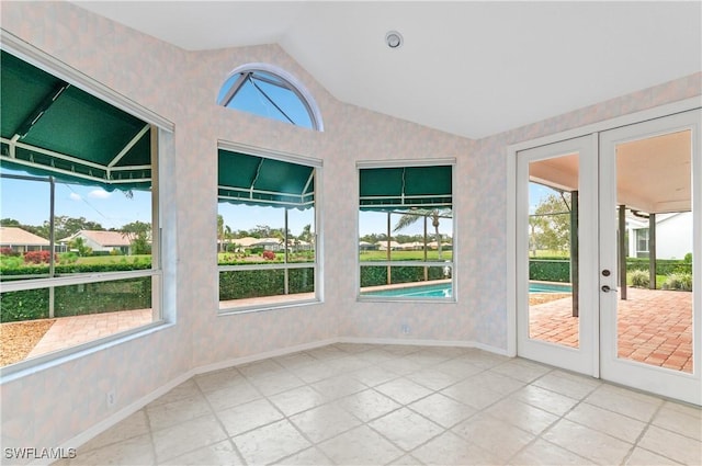 unfurnished sunroom with vaulted ceiling and french doors