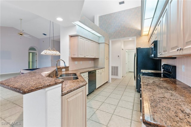 kitchen with kitchen peninsula, decorative light fixtures, tasteful backsplash, sink, and black appliances