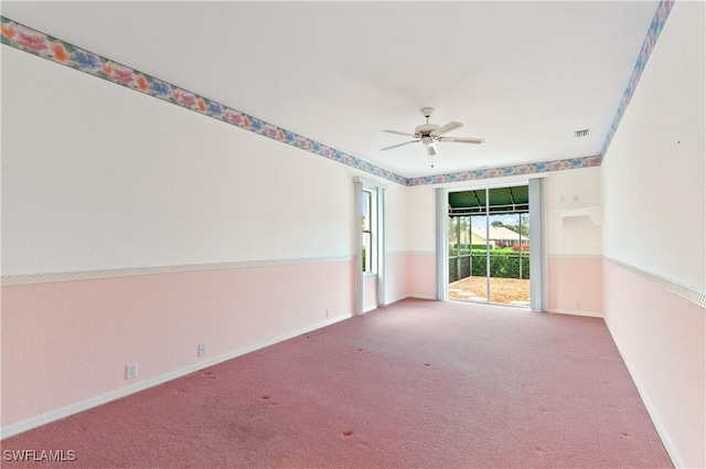 spare room with ceiling fan and light colored carpet