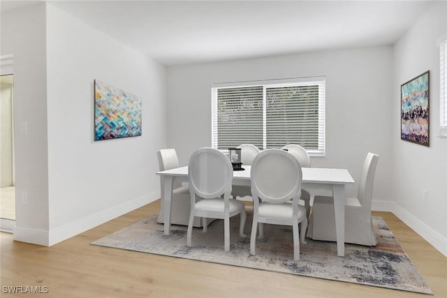 dining space with light hardwood / wood-style floors