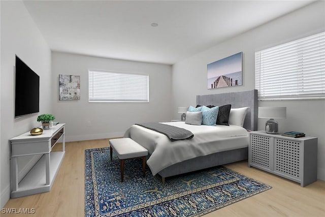 bedroom featuring light hardwood / wood-style floors and multiple windows