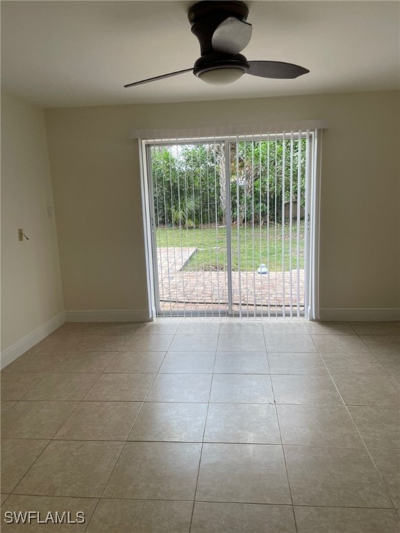 spare room with ceiling fan and light tile patterned flooring