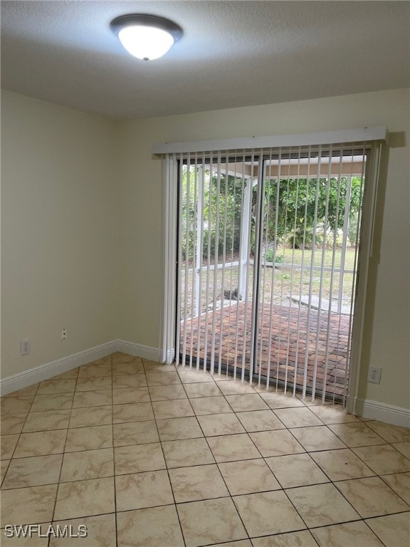 tiled empty room with a wealth of natural light