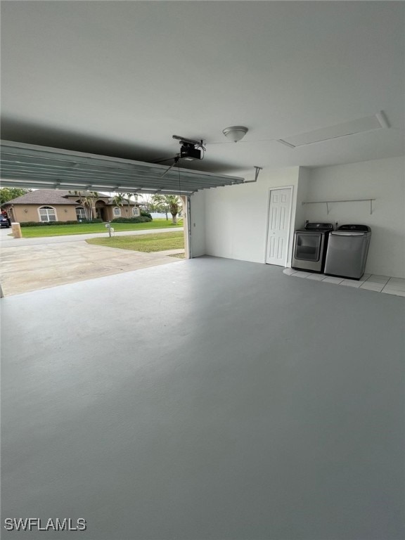 garage with a garage door opener and washing machine and clothes dryer