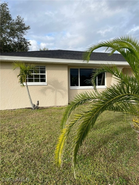 view of property exterior featuring a lawn