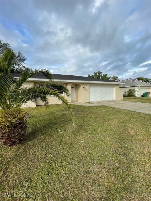 view of front of house with a front yard and a garage