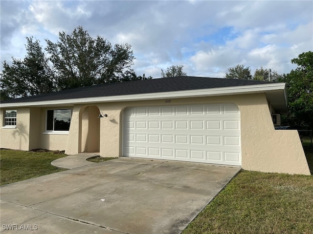 ranch-style home with a front yard and a garage