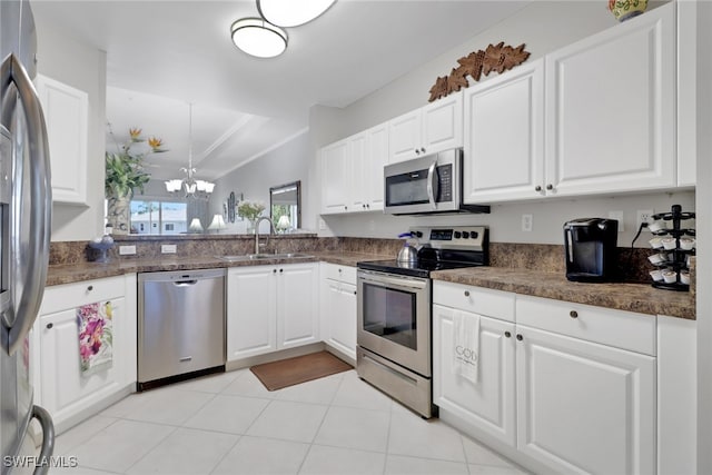 kitchen featuring sink, light tile patterned floors, appliances with stainless steel finishes, a notable chandelier, and white cabinets