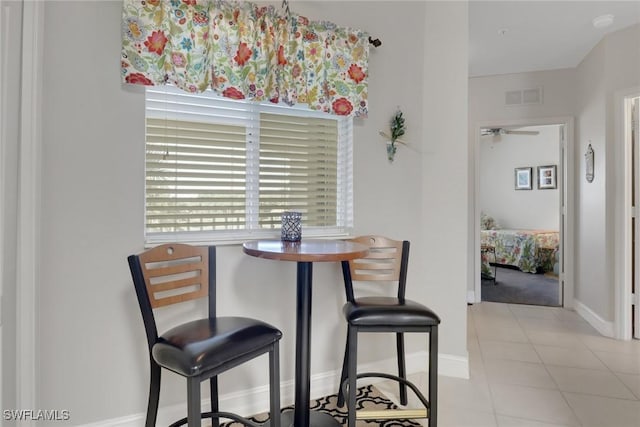 dining area with ceiling fan and light tile patterned floors