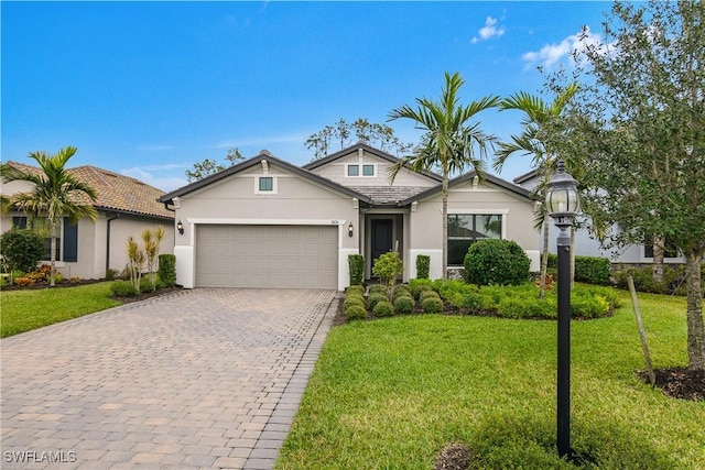 view of front of property with a garage and a front yard