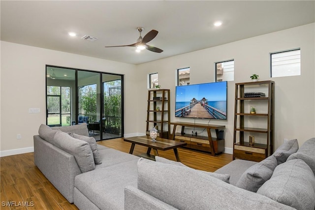 living room with ceiling fan and hardwood / wood-style floors