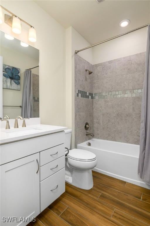 full bathroom featuring toilet, shower / tub combo, and vanity