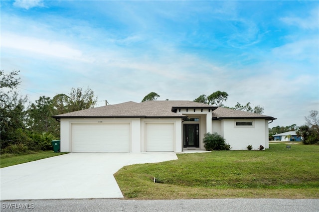 view of front of home with a front lawn and a garage