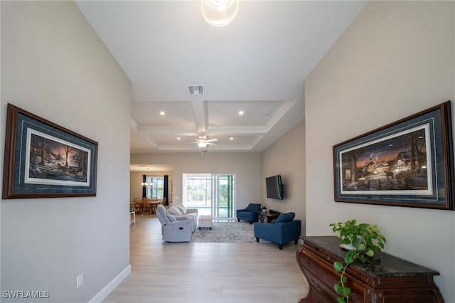 living room featuring ceiling fan, light hardwood / wood-style floors, beam ceiling, and coffered ceiling