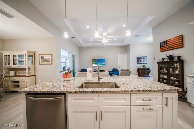 kitchen with stainless steel dishwasher, white cabinets, decorative light fixtures, and sink