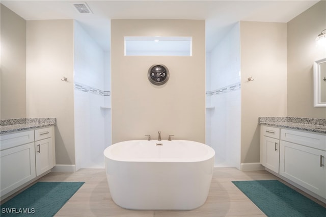 bathroom with tile patterned floors, separate shower and tub, and vanity