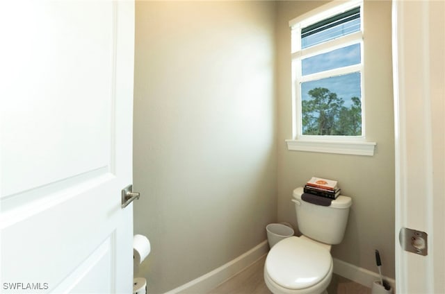 bathroom with plenty of natural light and toilet