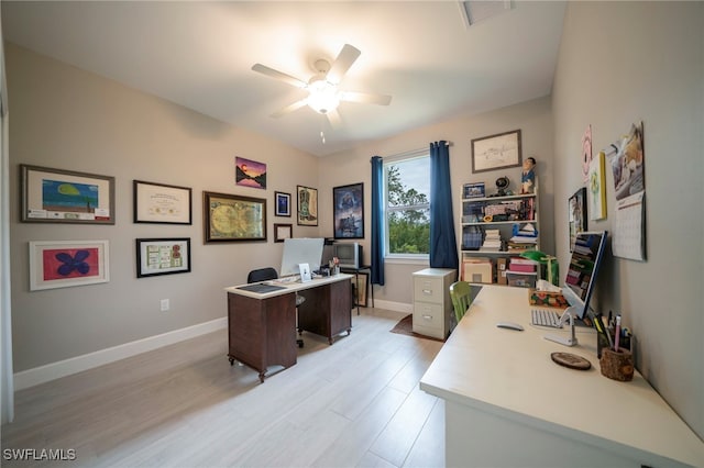 office space with light wood-type flooring and ceiling fan