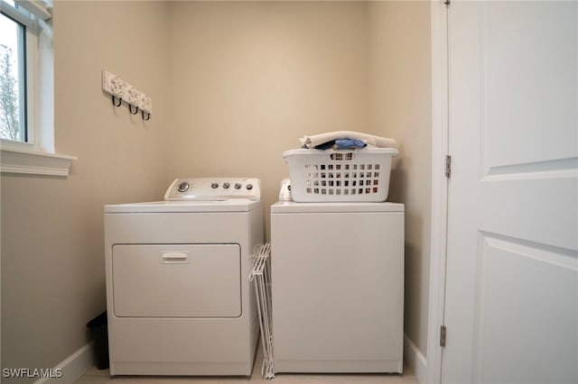 clothes washing area with separate washer and dryer