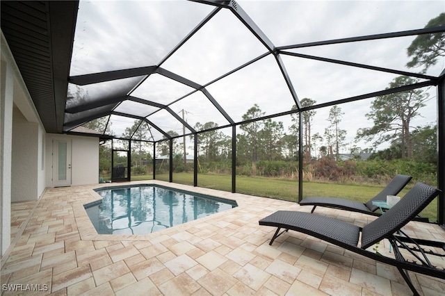 view of pool featuring a lanai, a patio area, and a yard