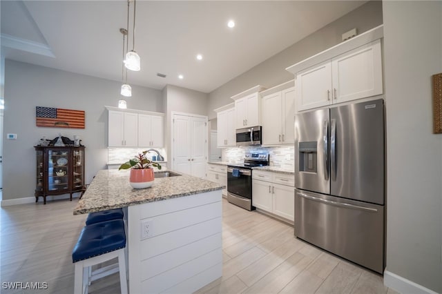 5435 Montego Ln, Port Charlotte, FL 33981 - kitchen with appliances with stainless steel finishes, a sink, tasteful backsplash, white cabinets, and recessed lighting