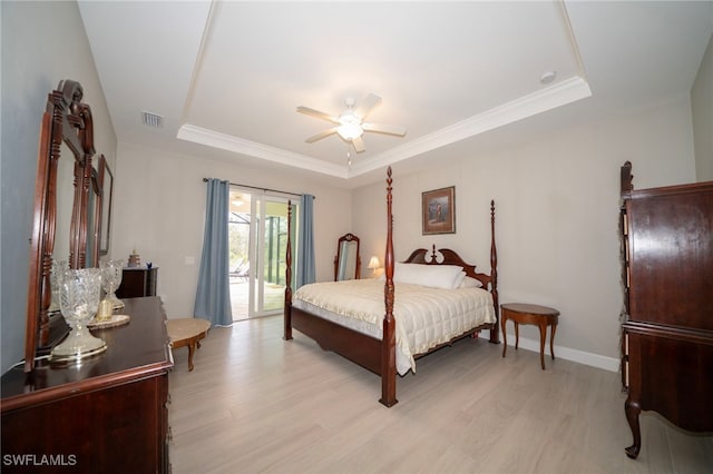 5435 Montego Ln, Port Charlotte, FL 33981 - bedroom featuring a raised ceiling, access to exterior, light wood-style floors, ceiling fan, and crown molding