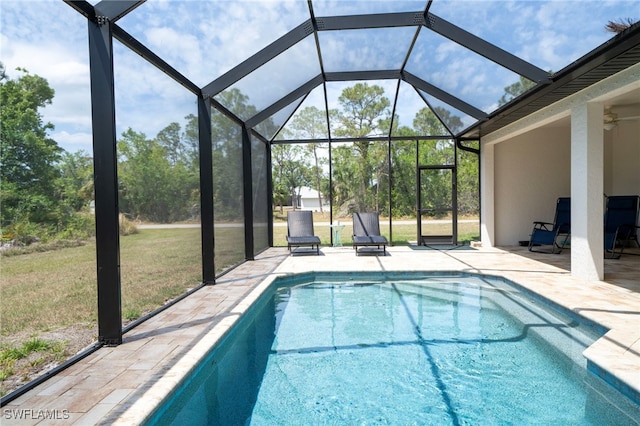 5435 Montego Ln, Port Charlotte, FL 33981 - outdoor pool with a patio, a lawn, ceiling fan, and glass enclosure