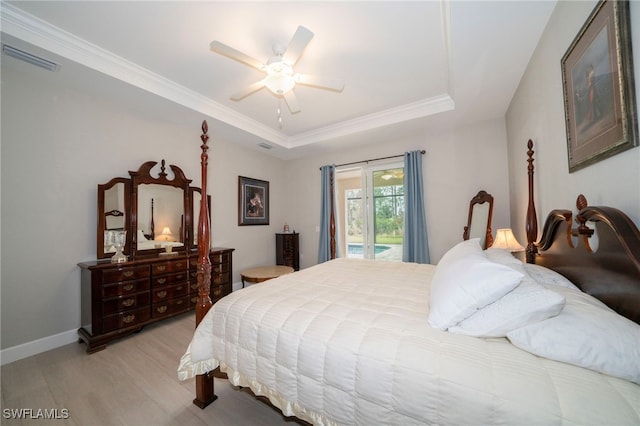 5435 Montego Ln, Port Charlotte, FL 33981 - bedroom featuring access to outside, light wood-type flooring, a raised ceiling, ceiling fan, and ornamental molding