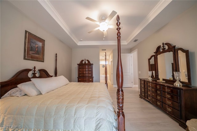 5435 Montego Ln, Port Charlotte, FL 33981 - bedroom featuring a raised ceiling, crown molding, light wood-style flooring, a ceiling fan, and ensuite bathroom