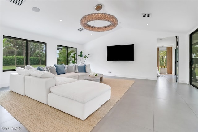 living area featuring vaulted ceiling, visible vents, and baseboards