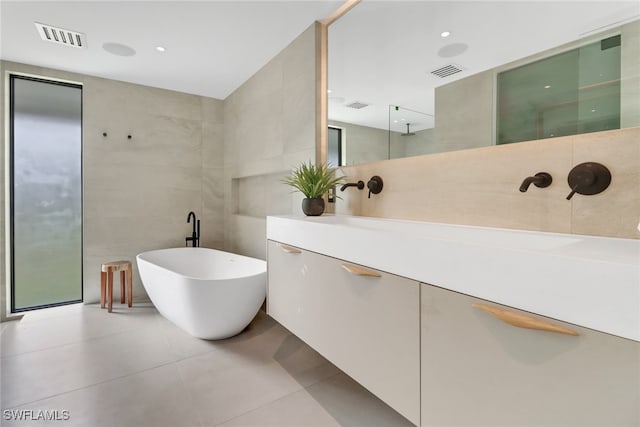 full bath with walk in shower, visible vents, and tile walls