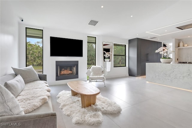 living area with a wealth of natural light, visible vents, and a fireplace