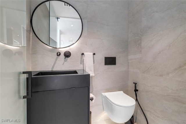 bathroom featuring toilet, tile walls, and vanity