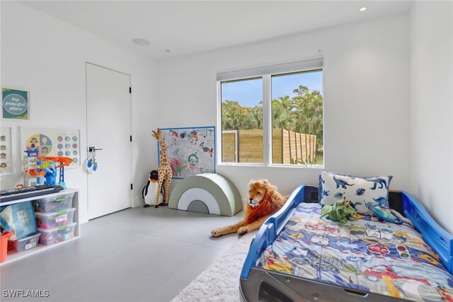 bedroom featuring concrete floors and recessed lighting