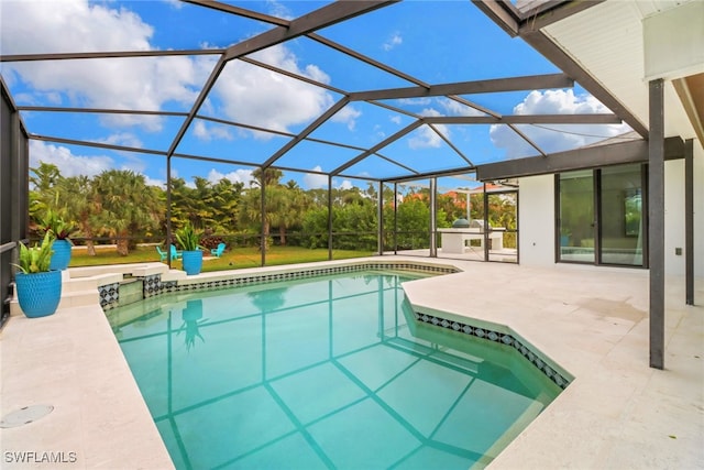 pool with a patio area and glass enclosure