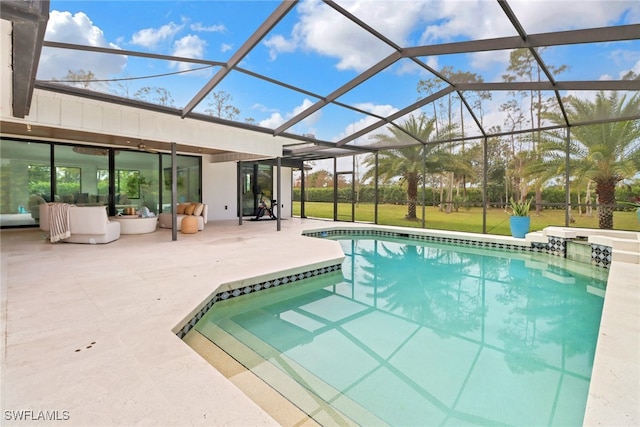 outdoor pool with glass enclosure, a lawn, and a patio area