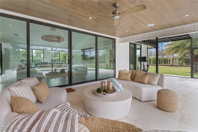 sunroom / solarium with a ceiling fan and wood ceiling