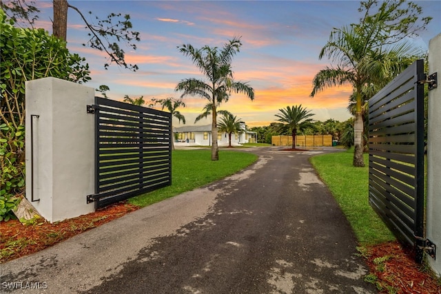 view of gate featuring a lawn