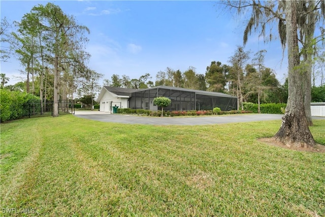 view of yard with a lanai and a garage