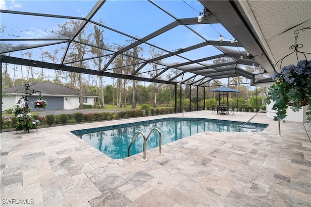 view of swimming pool with a patio area and glass enclosure