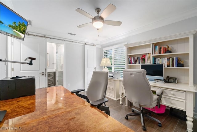 office area with dark wood-type flooring, crown molding, and ceiling fan