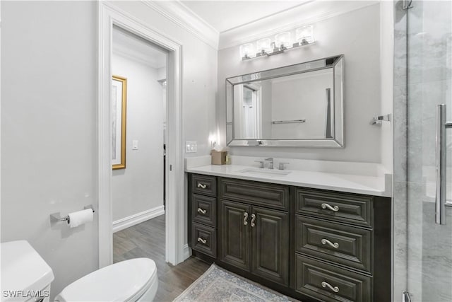 bathroom featuring toilet, hardwood / wood-style flooring, an enclosed shower, crown molding, and vanity