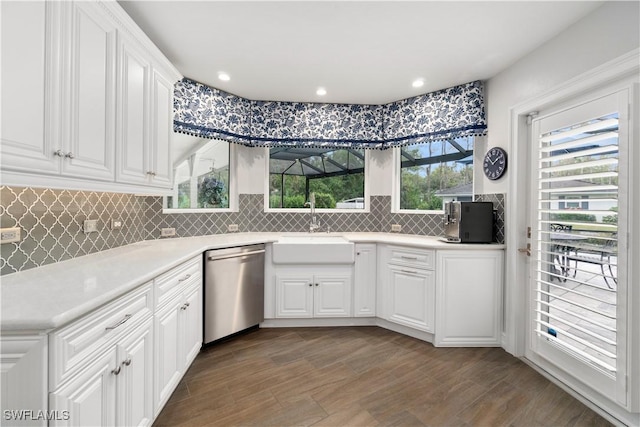 kitchen featuring white cabinetry, dishwasher, hardwood / wood-style floors, and sink