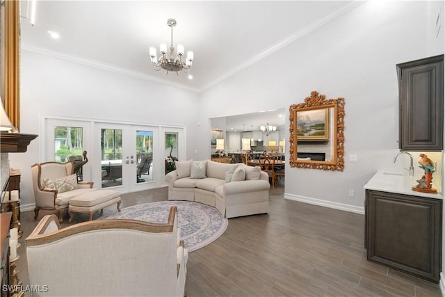 living room with dark wood-type flooring, crown molding, high vaulted ceiling, and a notable chandelier